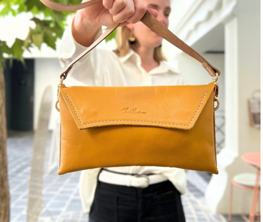 Handmade full-grain ochre yellow leather Crescent Clutch Bag with two-toned design – versatile clutch or crossbody with adjustable strap. Perfect for stylish women, features compartments for phone and cards.